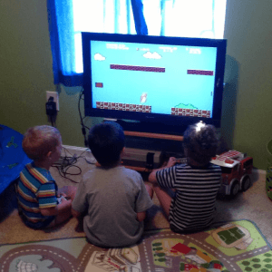 Me (Nathan) in the middle playing Super Mario Bros, with my brothers on the left (Gavin) and right (Kai)