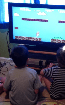 Nathan Parker in the middle playing Super Mario Bros, with my brothers on the left (Gavin) and right (Kai)